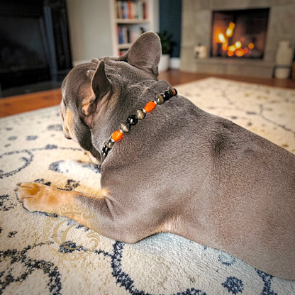 French Bulldog Maurice with a CollarCrafts dog collar Noir Ember in an cozy home setting with a fireplace in the background