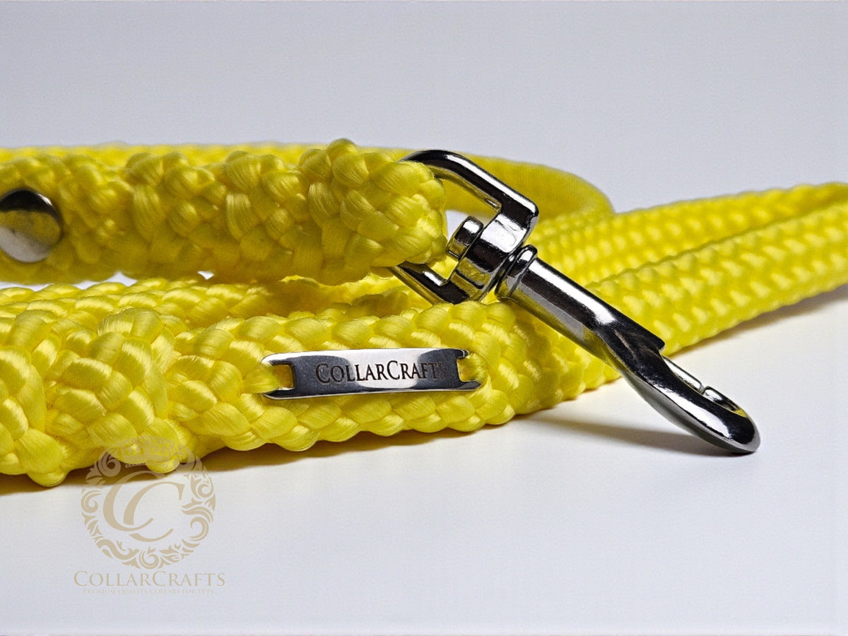Yellow dog leash with metal clasp on a white background, featuring CollarCrafts branding.
